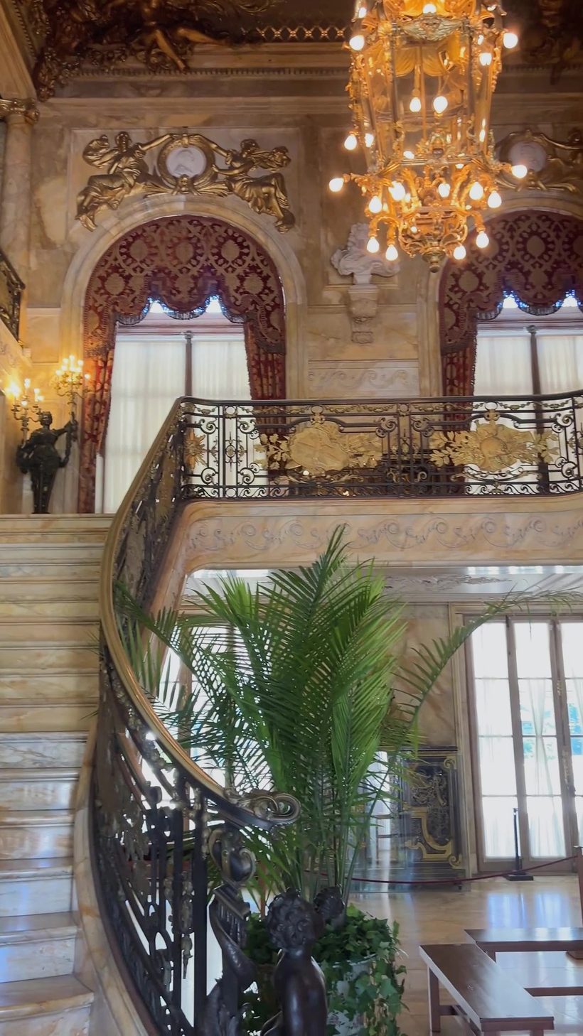 The marble staircase at Marble House, gilt lantern hanging over the turn