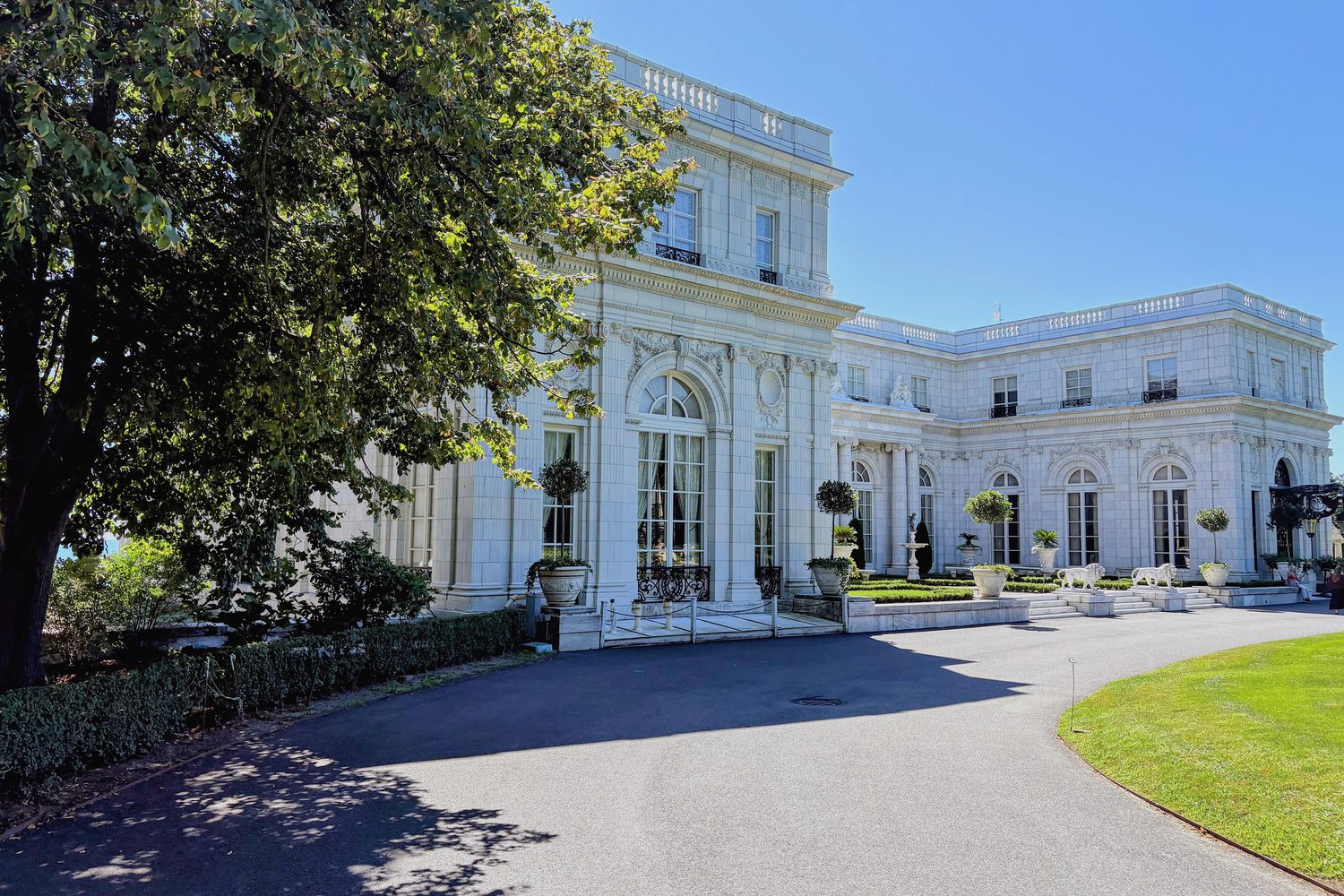 Rosecliff seen from its drive, white terracotta under summer trees