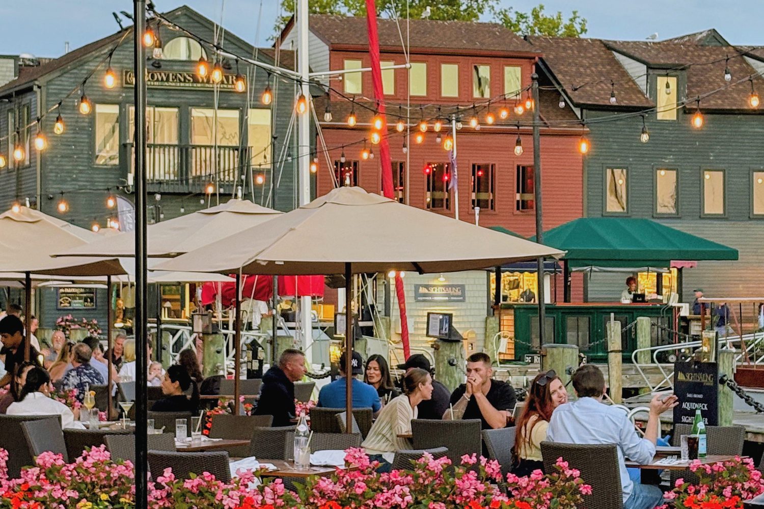 Bowen's Wharf at dusk, string lights over the tables